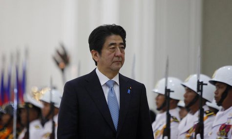 Japan's Prime Minister Shinzo Abe (C) inspects an honour guard at the Council of Ministers in central Phnom Penh November 16, 2013. Abe is i Japan's Prime Minister Shinzo Abe (C) inspects an honour guard at the Council of Ministers in central Phnom Penh November 16, 2013. Abe is i