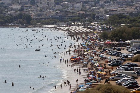 Tourists enjoy the hot weather at Vari beach, some 30 km (19 miles) southeast of Athens July 21, 2013. REUTERS/Yannis Behrakis Tourists enjoy the hot weather at Vari beach, some 30 km (19 miles) southeast of Athens July 21, 2013. REUTERS/Yannis Behrakis