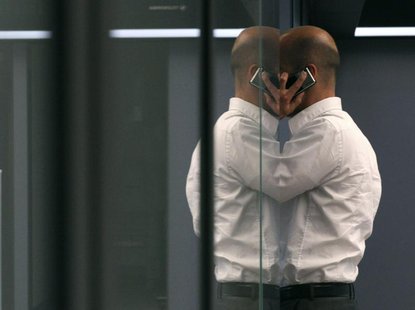 A bourse trader uses a cell phone during a trading session on the trading floor at Frankfurt's stock exchange August 2, 2011. REUTERS/Ralph A bourse trader uses a cell phone during a trading session on the trading floor at Frankfurt's stock exchange August 2, 2011. REUTERS/Ralph