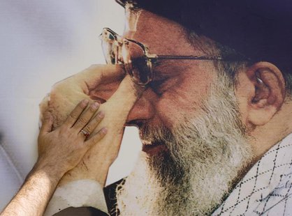 An Iranian digital printing technician pastes a picture of Iran's Supreme Leader Ayatollah Ali Khamenei in the Imam Khomeini Mausoleum in ce An Iranian digital printing technician pastes a picture of Iran's Supreme Leader Ayatollah Ali Khamenei in the Imam Khomeini Mausoleum in ce