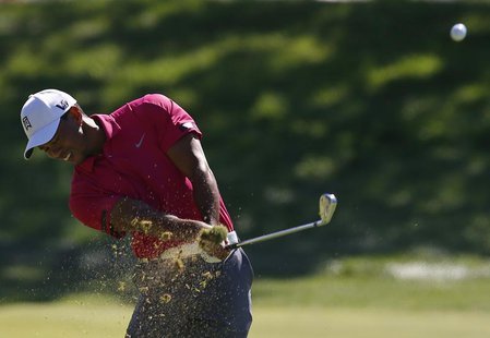 Tiger Woods of the U.S. hits an approach shot on the first hole during the third round of the BMW Championship golf tournament at the Conway Tiger Woods of the U.S. hits an approach shot on the first hole during the third round of the BMW Championship golf tournament at the Conway