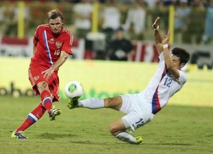 Park Jong-woo (R) of South Korea fights for the ball with Dmitry Tarasov of Russia during their international friendly soccer match at Al Wa Park Jong-woo (R) of South Korea fights for the ball with Dmitry Tarasov of Russia during their international friendly soccer match at Al Wa