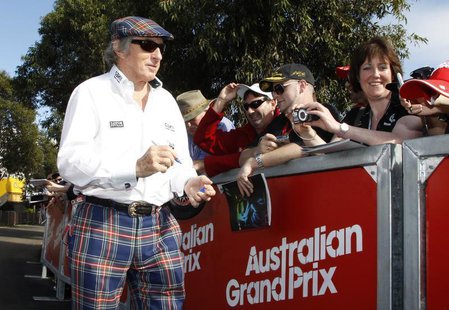 Former Formula One champion driver Jackie Stewart of Britain signs autographs as he arrives at the Albert Park circuit for the third practic Former Formula One champion driver Jackie Stewart of Britain signs autographs as he arrives at the Albert Park circuit for the third practic