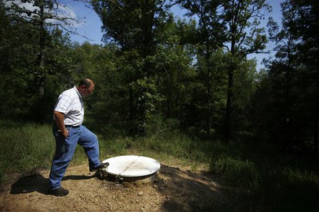 Arkansas Geological Society Geohazards Supervisor Scott Ausbrooks stands over a vault which houses a seismometer in Woolly Hollow State Park Arkansas Geological Society Geohazards Supervisor Scott Ausbrooks stands over a vault which houses a seismometer in Woolly Hollow State Park