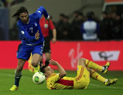 Georgios Samaras (L) of Greece controls the ball past Ovidiu Hoban of Romania during their 2014 World Cup qualifying soccer match in Buchare Georgios Samaras (L) of Greece controls the ball past Ovidiu Hoban of Romania during their 2014 World Cup qualifying soccer match in Buchare