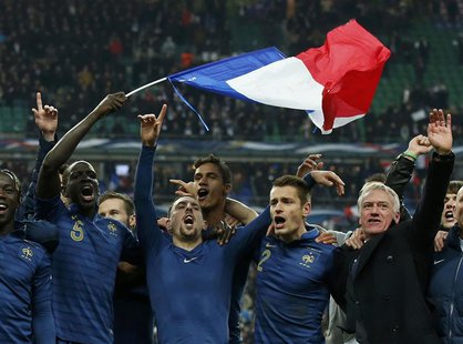 France's soccer team coach Didier Deschamps (R) and team mates celebrate after winning their 2014 World Cup qualifying second leg playoff so France's soccer team coach Didier Deschamps (R) and team mates celebrate after winning their 2014 World Cup qualifying second leg playoff so