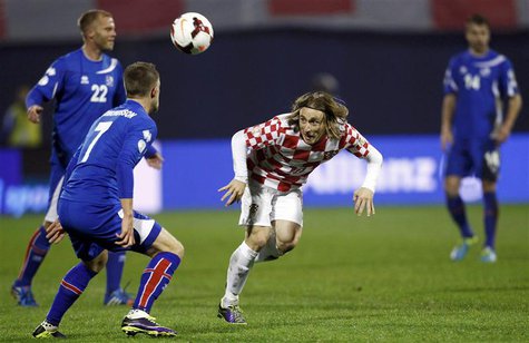 Croatia's Luka Modric (2ndR) challenges Iceland's Johann Gudmudsson (2ndL) and Eidur Smari Gudjohnsen (L) during their 2014 World Cup playof Croatia's Luka Modric (2ndR) challenges Iceland's Johann Gudmudsson (2ndL) and Eidur Smari Gudjohnsen (L) during their 2014 World Cup playof
