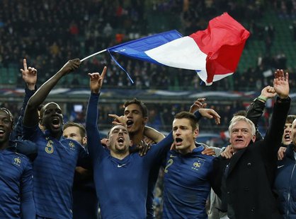 France's soccer team coach Didier Deschamps (R) and team mates celebrate after winning their 2014 World Cup qualifying second leg playoff so France's soccer team coach Didier Deschamps (R) and team mates celebrate after winning their 2014 World Cup qualifying second leg playoff so