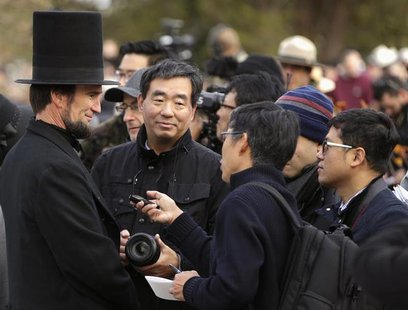 A re-enactor portraying U.S. President Abraham Lincoln (L) is interviewed by Japanese journalists at the Gettysburg National Cemetery in Pen A re-enactor portraying U.S. President Abraham Lincoln (L) is interviewed by Japanese journalists at the Gettysburg National Cemetery in Pen