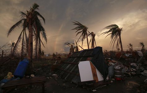 Part of a rainbow appears over the makeshift home of a family at the airport in the eastern Samar town of Guiuan November 20, 2013. REUTERS/ Part of a rainbow appears over the makeshift home of a family at the airport in the eastern Samar town of Guiuan November 20, 2013. REUTERS/