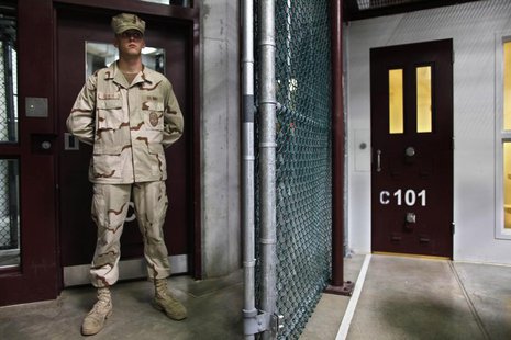 In this photo, reviewed by the U.S. military, a Guantanamo guard stands inside a doorway at Camp 6 detention facility at Guantanamo Bay U.S. In this photo, reviewed by the U.S. military, a Guantanamo guard stands inside a doorway at Camp 6 detention facility at Guantanamo Bay U.S.