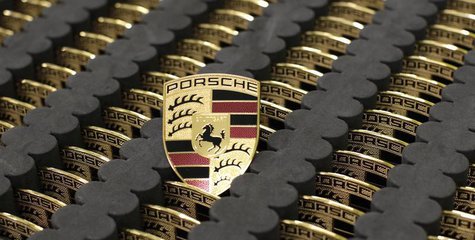 Car emblems for the new Porsche 918-Spyder are placed in a box at the production line of the German car manufacturer's plant in Stuttgart-Zu Car emblems for the new Porsche 918-Spyder are placed in a box at the production line of the German car manufacturer's plant in Stuttgart-Zu