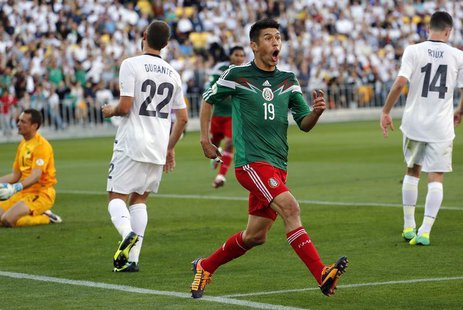 Mexico's Oribe Peralta celebrates after scoring a goal as New Zealand's Glen Moss, Andrew Durante and Storm Roux (L-R) react during their 20 Mexico's Oribe Peralta celebrates after scoring a goal as New Zealand's Glen Moss, Andrew Durante and Storm Roux (L-R) react during their 20