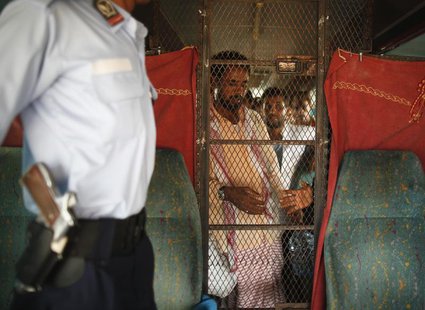 Yemeni workers, deported from Saudi Arabia, wait to leave a bus on which they were deported, at the Saudi al-Tewal border outpost with Yemen Yemeni workers, deported from Saudi Arabia, wait to leave a bus on which they were deported, at the Saudi al-Tewal border outpost with Yemen