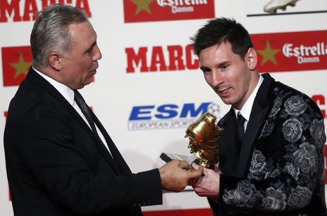 Barcelona's soccer player Lionel Messi (R) receives the Golden Boot trophy from former player Hristo Stoichkov during an award ceremony in B Barcelona's soccer player Lionel Messi (R) receives the Golden Boot trophy from former player Hristo Stoichkov during an award ceremony in B