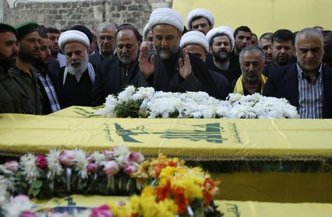 Lebanon's senior Hezbollah official Sheikh Nabil Qawouq (C) leads the prayer accompanied with Hezbollah parliament member Ali Ammar (centre Lebanon's senior Hezbollah official Sheikh Nabil Qawouq (C) leads the prayer accompanied with Hezbollah parliament member Ali Ammar (centre