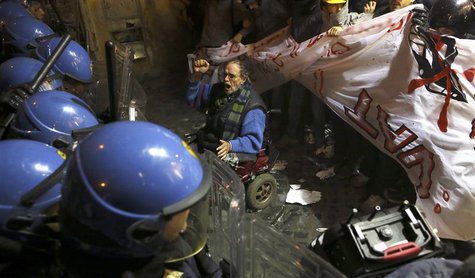 A demonstrator shouts in front of riot police in downtown Rome, during a protest against the construction of high-speed train line TAV, whic A demonstrator shouts in front of riot police in downtown Rome, during a protest against the construction of high-speed train line TAV, whic