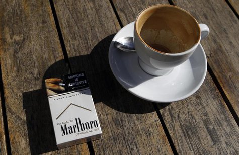 A Marlboro cigarettes pack, a brand of Philip Morris Tobacco, lies next to an empty coffee cup at a cafe in central Sydney June 27, 2011. RE A Marlboro cigarettes pack, a brand of Philip Morris Tobacco, lies next to an empty coffee cup at a cafe in central Sydney June 27, 2011. RE