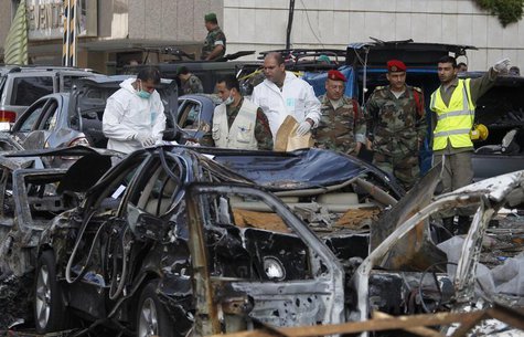 Forensic inspectors and Lebanese army soldiers examine the site of the two suicide bombings that occurred on Tuesday near Iran's embassy com Forensic inspectors and Lebanese army soldiers examine the site of the two suicide bombings that occurred on Tuesday near Iran's embassy com