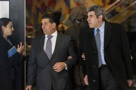 Detective Wojciech Braszczok (covered) exits Manhattan Supreme Court in New York, November 20, 2013. REUTERS/Brendan McDermid Detective Wojciech Braszczok (covered) exits Manhattan Supreme Court in New York, November 20, 2013. REUTERS/Brendan McDermid