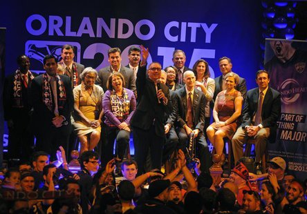 Orlando City SC president Phil Rawlins waves to his wife during a rally for a Major League Soccer official announcement for a expansion fran Orlando City SC president Phil Rawlins waves to his wife during a rally for a Major League Soccer official announcement for a expansion fran