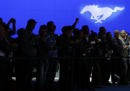 The Ford motor company logo for their Mustang brand is shown above attendees at the 2013 Los Angeles Auto Show in Los Angeles, California No The Ford motor company logo for their Mustang brand is shown above attendees at the 2013 Los Angeles Auto Show in Los Angeles, California No