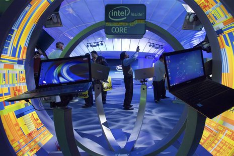 Gopi Sirineni (C) of San Jose, California takes a video of the Intel booth during the 2012 International Consumer Electronics Show (CES) in Gopi Sirineni (C) of San Jose, California takes a video of the Intel booth during the 2012 International Consumer Electronics Show (CES) in