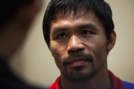 Boxer Manny Pacquiao of the Philippines looks on during a news conference at the Venetian Macao hotel in Macau November 19, 2013. REUTERS/Ty Boxer Manny Pacquiao of the Philippines looks on during a news conference at the Venetian Macao hotel in Macau November 19, 2013. REUTERS/Ty