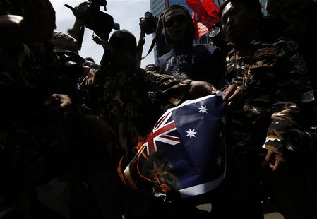 Protesters burn an Australian flag during a protest in front of the Australia embassy in Jakarta, November 21, 2013. Australia warned travel Protesters burn an Australian flag during a protest in front of the Australia embassy in Jakarta, November 21, 2013. Australia warned travel