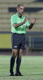 Referee Ali Sabbagh gestures during the AFC Cup soccer match between Kuwait's Al Qadsia and Yemen's Al Saqr in Kuwait City April 12, 2011. R Referee Ali Sabbagh gestures during the AFC Cup soccer match between Kuwait's Al Qadsia and Yemen's Al Saqr in Kuwait City April 12, 2011. R