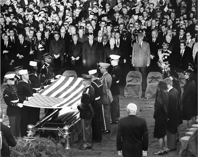 Mourners look on during the burial and folding of the flag ceremony for former U.S. President John F. Kennedy at Arlington National Cemetery Mourners look on during the burial and folding of the flag ceremony for former U.S. President John F. Kennedy at Arlington National Cemetery