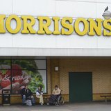 People sit outside a Morrisons supermarket in Stratford, east London, May 17, 2013. REUTERS/Paul Hackett People sit outside a Morrisons supermarket in Stratford, east London, May 17, 2013. REUTERS/Paul Hackett