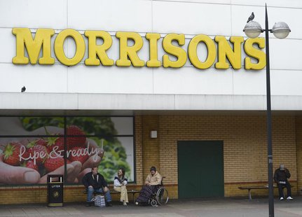 People sit outside a Morrisons supermarket in Stratford, east London, May 17, 2013. REUTERS/Paul Hackett People sit outside a Morrisons supermarket in Stratford, east London, May 17, 2013. REUTERS/Paul Hackett