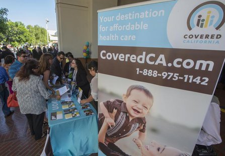 People sign up for health insurance information at a Covered California event which marks the opening of the state's Affordable Healthcare A People sign up for health insurance information at a Covered California event which marks the opening of the state's Affordable Healthcare A
