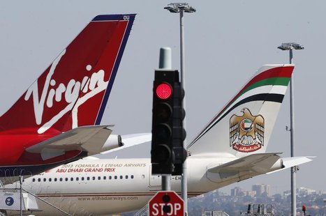 Virgin and Etihad planes are parked next to each other at Kingsford Smith airport in Sydney August 30, 2013. REUTERS/Daniel Munoz Virgin and Etihad planes are parked next to each other at Kingsford Smith airport in Sydney August 30, 2013. REUTERS/Daniel Munoz