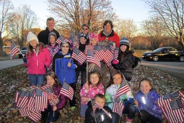 Holding some of the flags collected from the graves of veterans at Holy Cross Cemetery are (back row) Sexton Dan Ristow, parent, Deb Tryba, teacher advisor, Dawn Street. (middle row) Elli Renzelmann, Gabrielle Bricko, Austin Tryba, Nevaeh Ehaney, Ava Wittstock, Ella Smith. (front row) Meghan Flook, Lillian Berry-Street, Hannah Hasenstein, Khloe Murphy, Landon Berry-Street. Holding some of the flags collected from the graves of veterans at Holy Cross Cemetery are (back row) Sexton Dan Ristow, parent, Deb Tryba, teacher advisor, Dawn Street. (middle row) Elli Renzelmann, Gabrielle Bricko, Austin Tryba, Nevaeh Ehaney, Ava Wittstock, Ella Smith. (front row) Meghan Flook, Lillian Berry-Street, Hannah Hasenstein, Khloe Murphy, Landon Berry-Street.