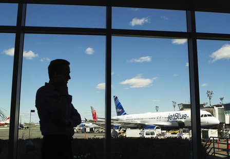 A man talks on his cell phone while looking at a JetBlue Airways plane at LaGuardia Airport in New York April 5, 2012. REUTERS/Lucas Jackson A man talks on his cell phone while looking at a JetBlue Airways plane at LaGuardia Airport in New York April 5, 2012. REUTERS/Lucas Jackson