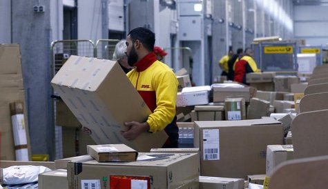 Workers load trucks with parcels at the new distribution centre of the German postal and logistics group Deutsche Post DHL in Berlin Novembe Workers load trucks with parcels at the new distribution centre of the German postal and logistics group Deutsche Post DHL in Berlin Novembe