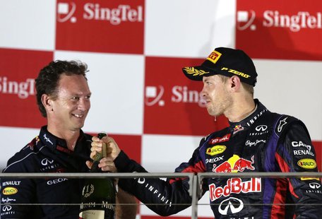 Red Bull team principal Christian Horner (L) celebrates on the podium with Red Bull Formula One driver Sebastian Vettel of Germany after Vet Red Bull team principal Christian Horner (L) celebrates on the podium with Red Bull Formula One driver Sebastian Vettel of Germany after Vet