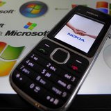 A Nokia mobile phone lies on a tablet computer showing logos of Microsoft, in this illustration picture taken in Frankfurt, November 18, 201 A Nokia mobile phone lies on a tablet computer showing logos of Microsoft, in this illustration picture taken in Frankfurt, November 18, 201