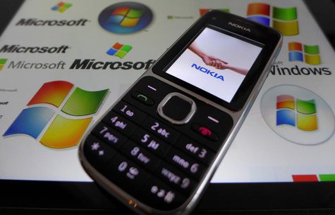 A Nokia mobile phone lies on a tablet computer showing logos of Microsoft, in this illustration picture taken in Frankfurt, November 18, 201 A Nokia mobile phone lies on a tablet computer showing logos of Microsoft, in this illustration picture taken in Frankfurt, November 18, 201