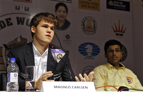 Norway's Magnus Carlsen speaks during a news conference as India's Viswanathan Anand (R) looks on after Carlsen clinched the FIDE World Ches Norway's Magnus Carlsen speaks during a news conference as India's Viswanathan Anand (R) looks on after Carlsen clinched the FIDE World Ches