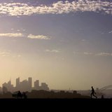 A man walks as another looks towards the city of Sydney on a hot summers day December 30, 2005. REUTERS/David Gray A man walks as another looks towards the city of Sydney on a hot summers day December 30, 2005. REUTERS/David Gray