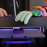 Twelve-year-old Leon McCarthy rests his prosthetic hand on a MarkerBot Replicator 2 Desktop 3D Printer at the new MakerBot store in Boston, Twelve-year-old Leon McCarthy rests his prosthetic hand on a MarkerBot Replicator 2 Desktop 3D Printer at the new MakerBot store in Boston,