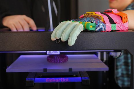 Twelve-year-old Leon McCarthy rests his prosthetic hand on a MarkerBot Replicator 2 Desktop 3D Printer at the new MakerBot store in Boston, Twelve-year-old Leon McCarthy rests his prosthetic hand on a MarkerBot Replicator 2 Desktop 3D Printer at the new MakerBot store in Boston,