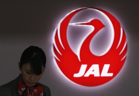 An employee of Japan Airlines works next to the company logo at Haneda Airport in Tokyo February 4, 2013. REUTERS/Toru Hanai An employee of Japan Airlines works next to the company logo at Haneda Airport in Tokyo February 4, 2013. REUTERS/Toru Hanai