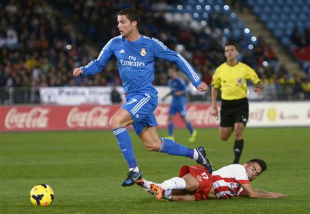 Real Madrid's Cristiano Ronaldo (top) is challenged by Almeria's Jesus Joaquin Fernandez "Suso" during their Spanish First Division soccer m Real Madrid's Cristiano Ronaldo (top) is challenged by Almeria's Jesus Joaquin Fernandez "Suso" during their Spanish First Division soccer m