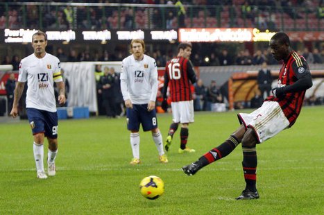 AC Milan's Mario Balotelli takes a penalty which was saved during their Italian Serie A soccer match against Genoa at San Siro stadium in Mi AC Milan's Mario Balotelli takes a penalty which was saved during their Italian Serie A soccer match against Genoa at San Siro stadium in Mi