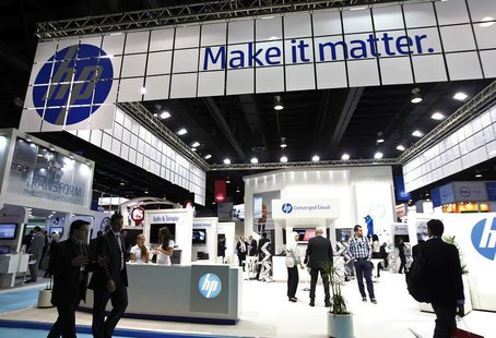 People walk past a Hewlett-Packard (HP) stand during the Gulf Information and Technology Exhibition (GITEX) at the Dubai World Trade Centre People walk past a Hewlett-Packard (HP) stand during the Gulf Information and Technology Exhibition (GITEX) at the Dubai World Trade Centre