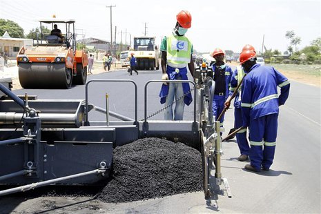 Labourers carry out surfacing work on a road near the Zambian capital Lusaka November 15, 2013. REUTERS/Mackson Wasamunu Labourers carry out surfacing work on a road near the Zambian capital Lusaka November 15, 2013. REUTERS/Mackson Wasamunu